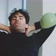 Young man stretching arms then taking bite of an apple while sitting - VideoHive Item for Sale
