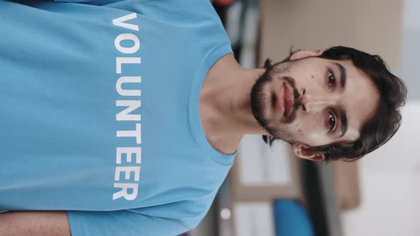 Portrait View of the Multiracial Man in Volunteer t Shirt Looking at the Camera with Serious Face