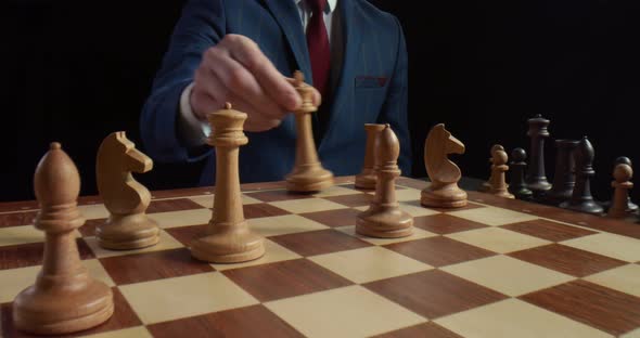 Close Up of Player Making Castling Move with Pieces Playing Chess Isolated on Black Background