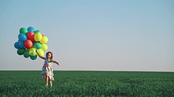 Happy Child Playing with Bright Multicolor Balloons 