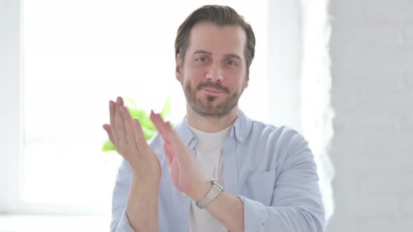 Portrait of Happy Young Man Clapping Applauding