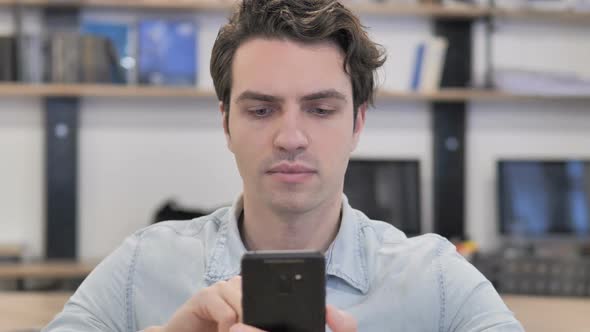 Portrait of Creative Man Using Smartphone in Office