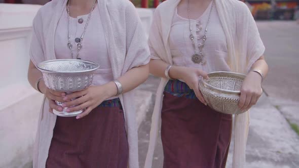 Two Girls With The Water Bowl Walking