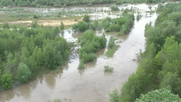 Rainfall move downstream of wide river 4K aerial video