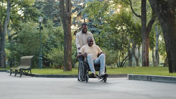 Cheerful Young Black Guy Visits Brother in Hospital Postop Walks Has Fun in Park with Relative or