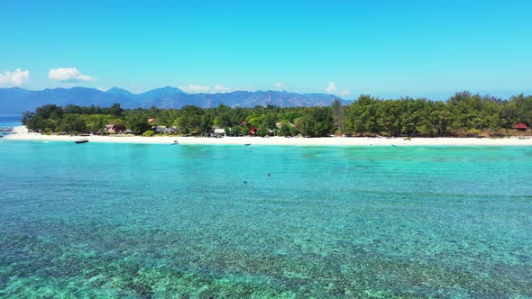 Natural fly over clean view of a white sand paradise beach and aqua blue ocean background in vibrant