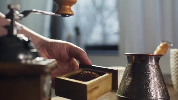 The Process of Grinding Coffee Beans in a Retro Mill