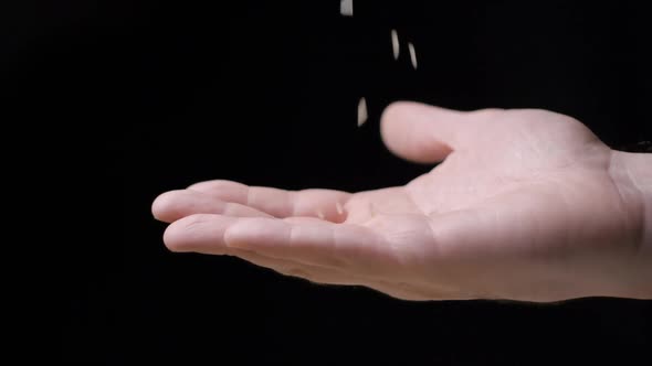 Rice falling in hand slow motion