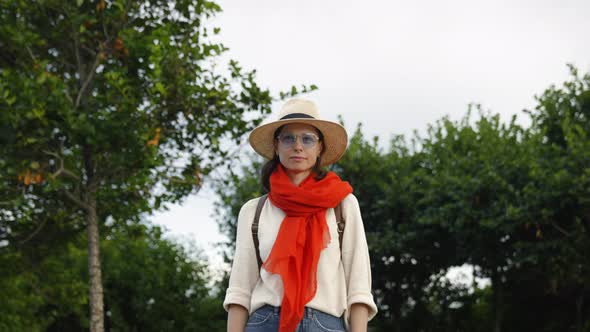 Young woman with red scarf looking ahead