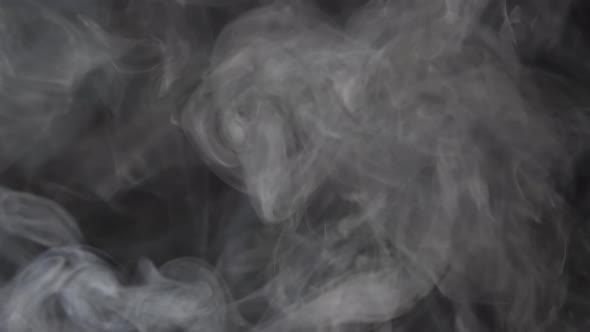 Smoke texture over blank black background. Mystical steam at night.