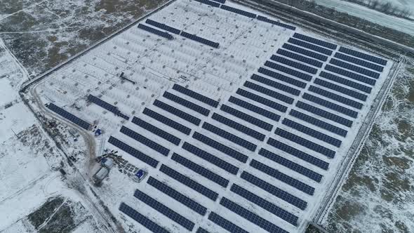 Aerial Footage of a Solar Power Station in Snow Construction During Winter