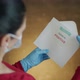 Woman Opening Envelope with Certificate with Positive Results in Covid-19. - VideoHive Item for Sale