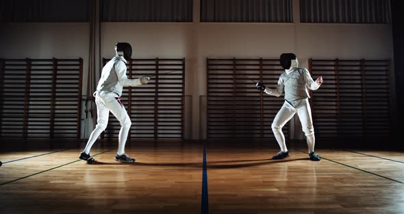 Two Men in Fencing Gear Duelling with Foils