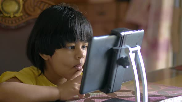 Child Girl Using Digital Tablet Sitting on a Hcair