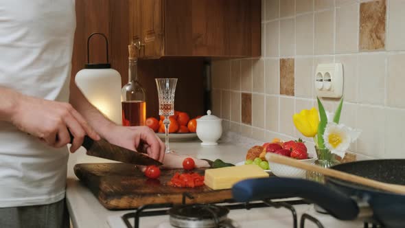 Close Up of an Young Man That Prepares Food in the Kitchen To His Lovely Wife