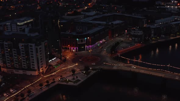 Aerial View of Cars Driving Through Roundabout at River Waterfront