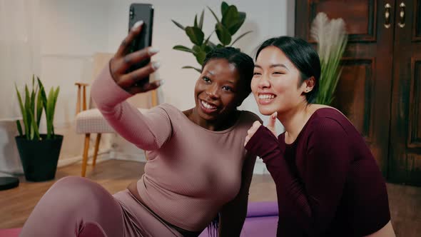 Zoom in Portrait of Diverse Women Friends Making Selfie on Smartphone Smiling and Gesturing Thumb Up