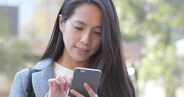 Business woman using smart phone at outdoor