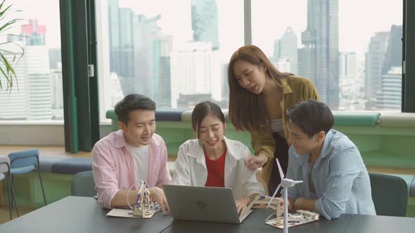 Group college university students talking and watching exam results in a laptop in university