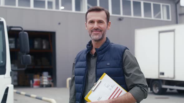 Portrait of caucasian mature man in front of warehouse. Shot with RED helium camera in 8K.