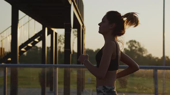 Side view of a young woman jogging