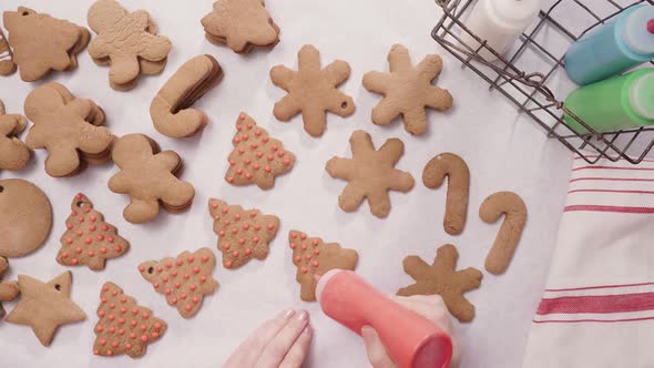 Decorating gingerbread cookies with royal icing for Christmas.