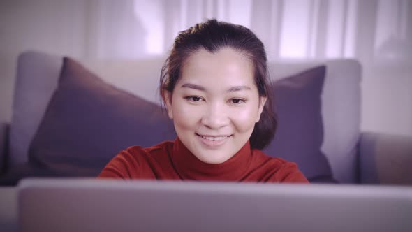 Businesswoman on redshirt using the laptop for meeting online and work from home in coronavirus