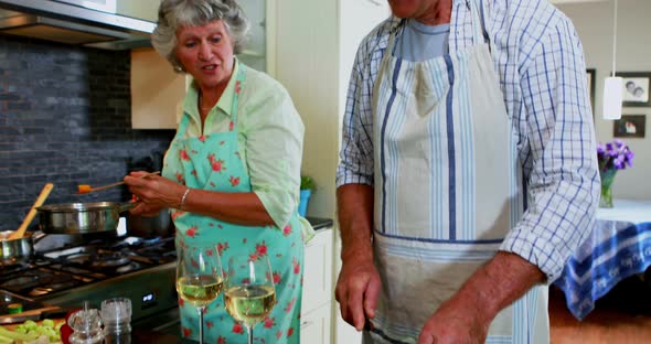 Senior couple tasting food cooking in kitchen 4k