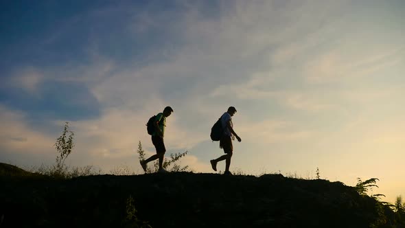 Silhouette Hikers Walking On The Mountain With Sunset