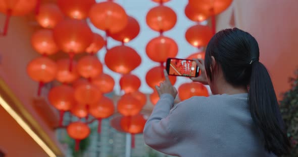 Woman look at the red lantern for decoration