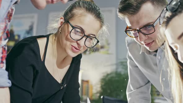 Young Woman Sharing Ideas with Coworkers