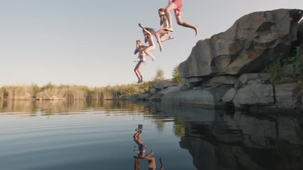 Slowmo of Young Friends Diving into Lake