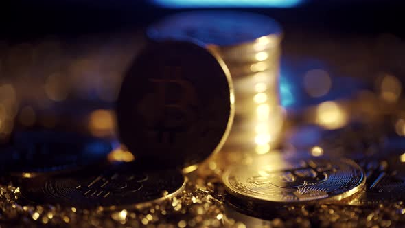 Golden Bitcoin Coins are Rotating on a Dark Background