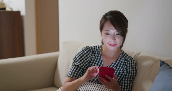 Woman check on the phone at home