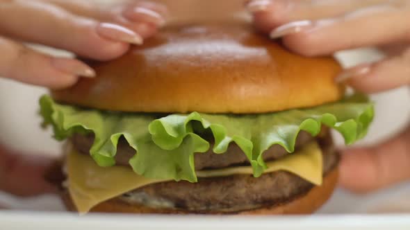 Woman Biting Big Fast Food Burger, Gaining Extra Weight, Saturated Fat, Closeup