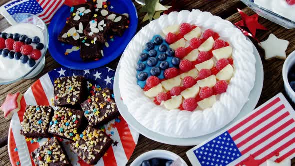 Fruitcake and various sweet foods arranged on wooden table