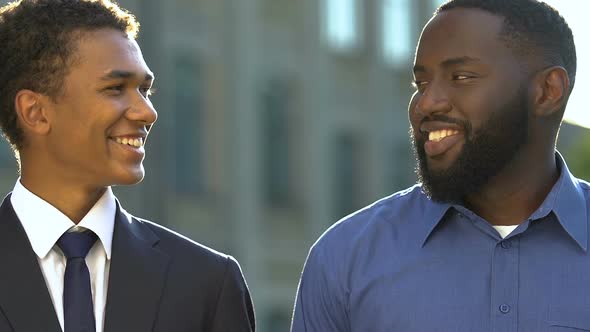 Proud Black Male Hugging Teenage Boy Feeling Happy, Family Support and Trust