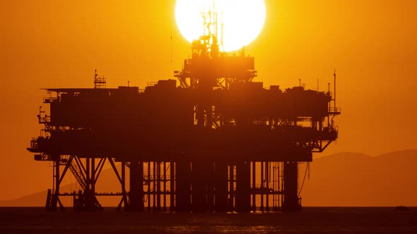 Time lapse of the sunset behind an offshore oil platform