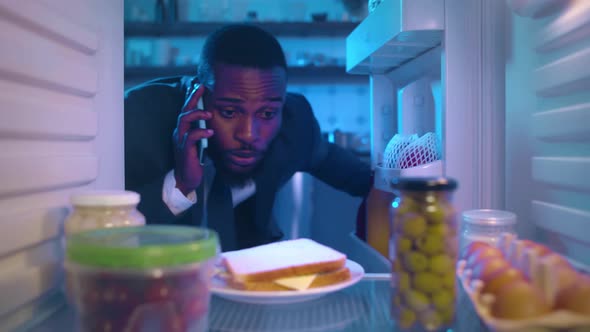 AfricanAmerican Ethnicity Businessman Taking Sandwich From Fridge