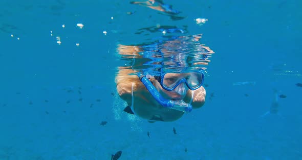 POV of beautiful young woman snorkeling