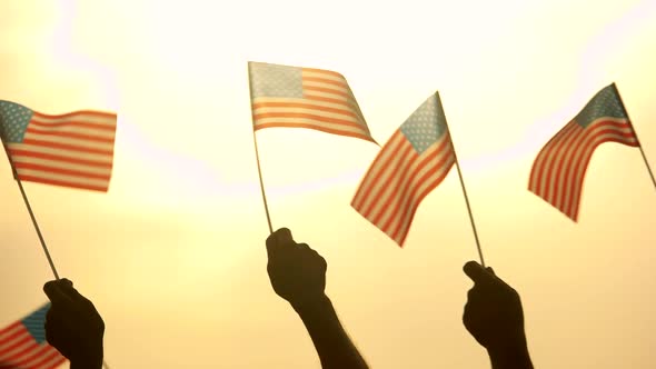 Close Up American Flags in Peoples Hands