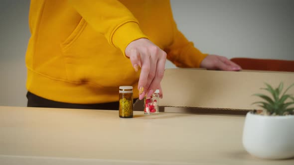 Young Woman Taking Medicine From Box