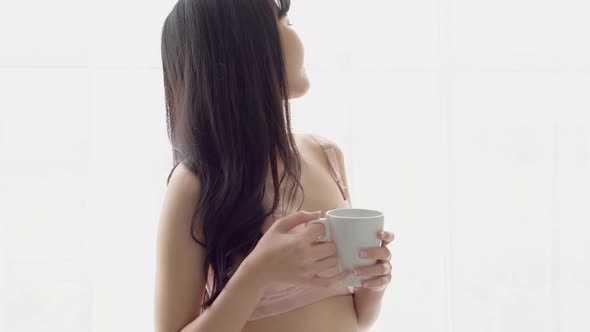 Beautiful young asian woman happy and confident drinking cup of coffee.