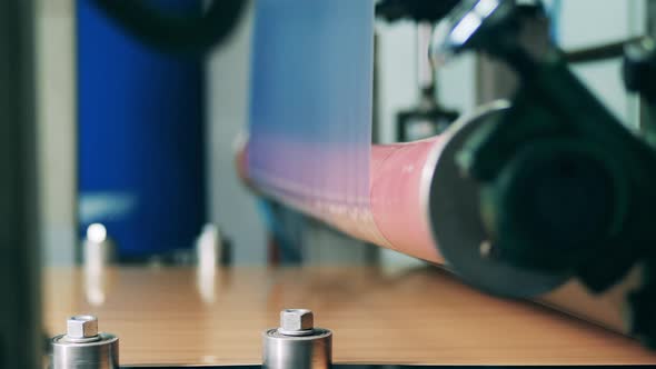 Transparent Foil Is Moving Through the Rolling Conveyor