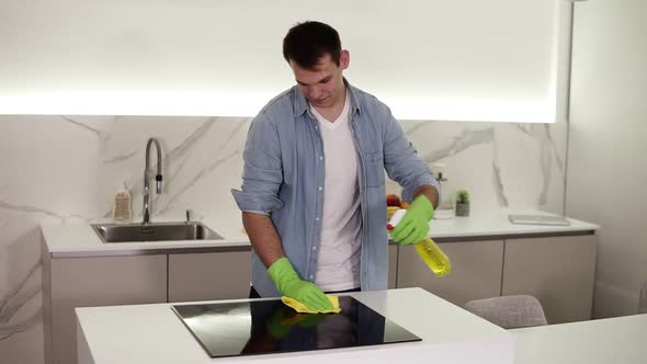 Tall Cheerful Caucasian Man in Blue Shirt Doing the Cleaning in the Kitchen Washing the Kitchen