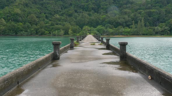 Empty pier with tropical island in the background.