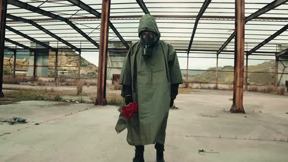 Soldier Lays on the Ground a Bouquet of Red Roses