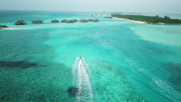 Aerial View of Jet Ski Racing on a Crystal Clear Turquoise Water in Maldives