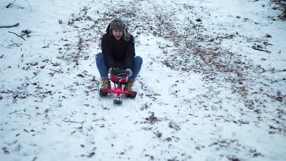 Young Man Goes Sledding in Winter