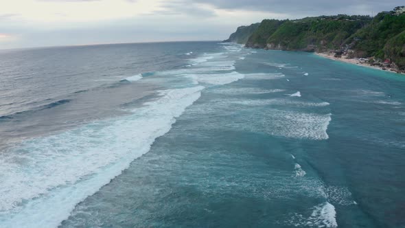 Aerial View of Beautiful Foamy Blue Sea Waves Splashing Towards